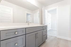 Bathroom with vanity, wood-type flooring, and a textured ceiling