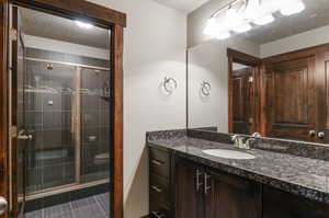 Bathroom with walk in shower, a textured ceiling, toilet, vanity, and tile patterned floors