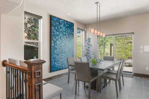 Tiled dining room featuring a textured ceiling