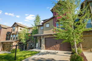 View of front of home with a garage and a front yard