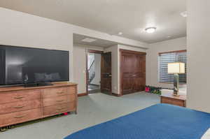 Carpeted bedroom featuring a textured ceiling