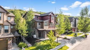 View of front of home with a garage and a front lawn