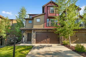 Craftsman-style house with a garage and a front yard