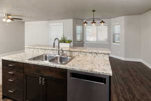 Kitchen with sink, dark hardwood / wood-style flooring, a kitchen island with sink, dishwasher, and ceiling fan