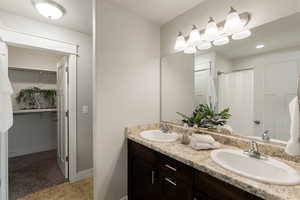 Bathroom with walk in shower and vanity