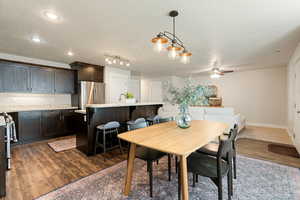 Dining room featuring ceiling fan, a textured ceiling, sink, and dark hardwood / wood-style flooring