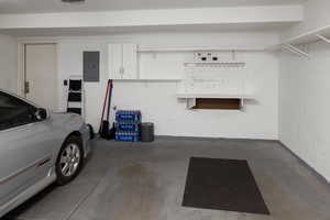 Garage featuring a garage door opener and electric panel