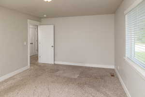 Empty room featuring carpet flooring