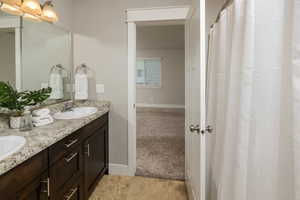 Bathroom with dual vanity and tile patterned floors