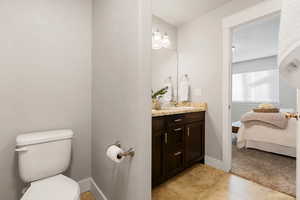 Bathroom featuring tile patterned flooring, vanity, and toilet