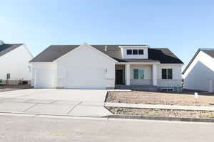 View of front of house with a garage and central AC