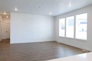 Empty room with dark hardwood / wood-style floors