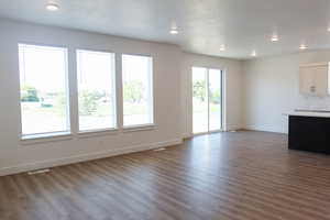 Unfurnished living room with dark hardwood / wood-style flooring