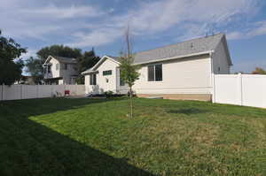 Rear view of property featuring a lawn