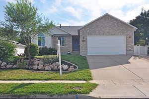 Ranch-style home with a garage and a front yard