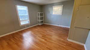 Empty room with light hardwood / wood-style flooring