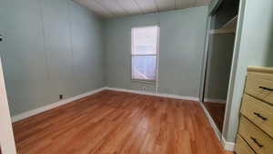 Unfurnished bedroom featuring ornamental molding and light wood-type flooring