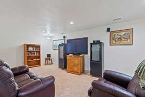 Basement Living room featuring light colored carpet