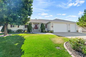 Ranch-style house with a garage and a front yard