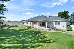 Back of property with a patio and a yard