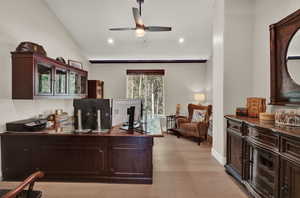 Office featuring light hardwood / wood-style floors, ceiling fan, and vaulted ceiling