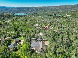 Birds eye view of property featuring a water and mountain view