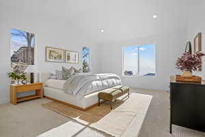 Primary bedroom with vaulted ceiling