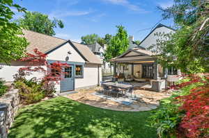 Rear view of property featuring a patio area and a lawn