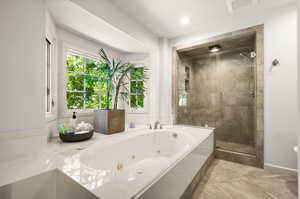 Bathroom with tile patterned floors and plus walk in shower