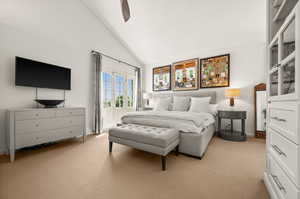 Primary Bedroom featuring light-colored carpet, ceiling fan, high vaulted ceiling and patio