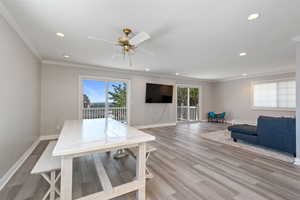 Dining room with ornamental molding, hardwood / wood-style flooring, and ceiling fan