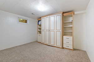 Unfurnished bedroom with light colored carpet