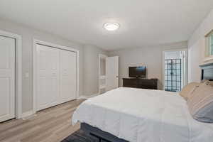 Bedroom with light hardwood / wood-style flooring