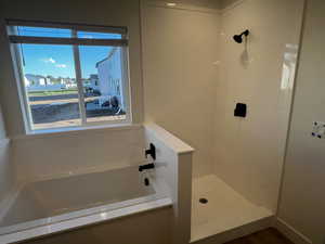 Bathroom featuring plus walk in shower