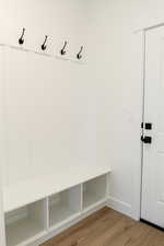 Mudroom with wood-type flooring