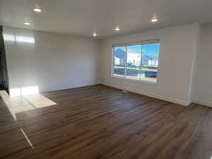 Unfurnished room featuring dark hardwood / wood-style floors