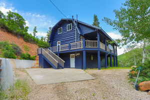 Rear view of property featuring a wooden deck