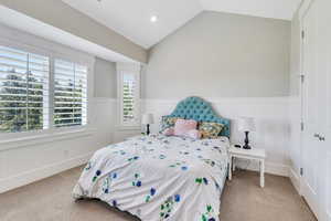 Carpeted bedroom with lofted ceiling