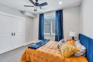 Bedroom featuring carpet flooring, a closet, and ceiling fan