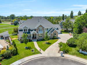 View of front of property featuring a garage and a front lawn