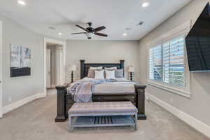 Bedroom featuring light carpet and ceiling fan