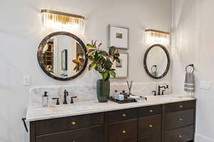 Bathroom with vanity and decorative backsplash