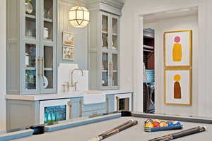 Details featuring hanging light fixtures, washer / dryer, and sink