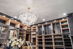 Spacious closet with an inviting chandelier