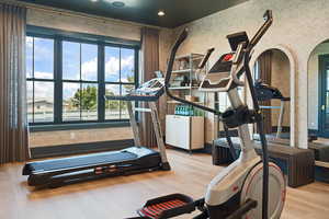 Exercise room with light wood-type flooring