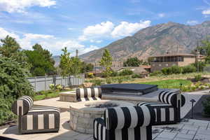 View of patio / terrace with a fire pit and a mountain view