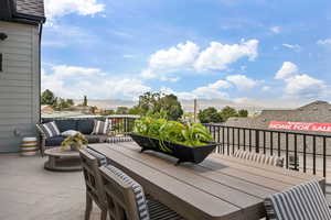 View of patio / terrace featuring a balcony, a mountain view, and an outdoor living space