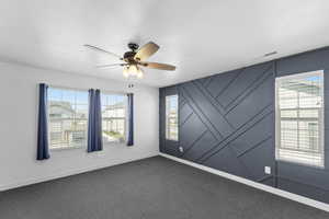 Primary bedroom with plenty of natural light and ceiling fan