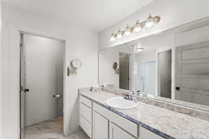 Primary Bathroom featuring tile patterned floors and vanity