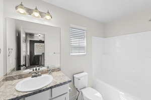 Full upstairs bathroom with vanity, shower /bath combination, and toilet